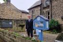 Rob Tindall next to the free library at Otley Funeralcare