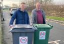 L-R: Cllrs Alderson and Wadsworth with two bins with the stickers warning against speeding