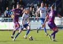 Gabriel Johnson (on the ball) delivered for Guiseley at the death