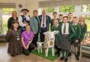Wharfeside staff and St Joseph's Primary School pupils are pictured with Otley Town Mayor Ray Smith, Otley bellman Terry Ford and mascot Baaarbara