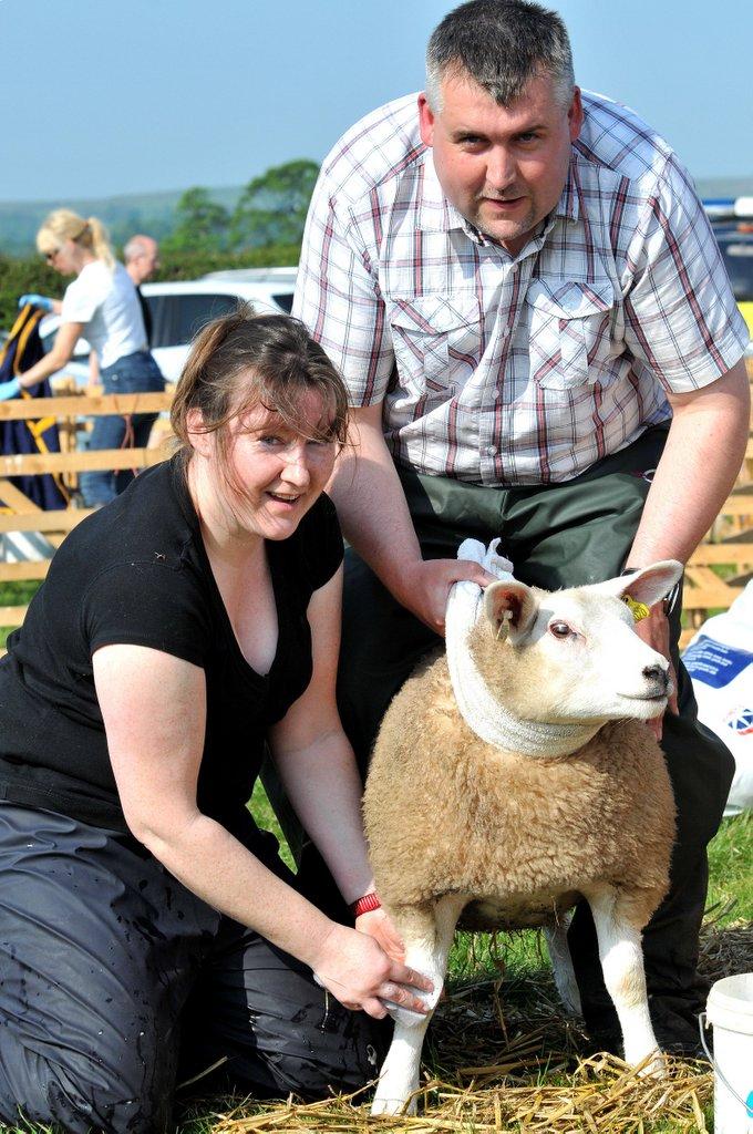 Matthew Prince and Elizabeth Dyson wash one of their Texel sheep.