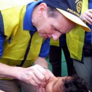 Roy Barker delivering polio vaccine in India.