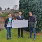 Members of Wildlife Friendly Otley receive the funding from a representative of the Co-op