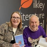 Gyles Brandreth signing his book for attendees of Ilkley Literature Festival