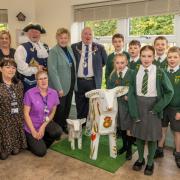 Wharfeside staff and St Joseph's Primary School pupils are pictured with Otley Town Mayor Ray Smith, Otley bellman Terry Ford and mascot Baaarbara
