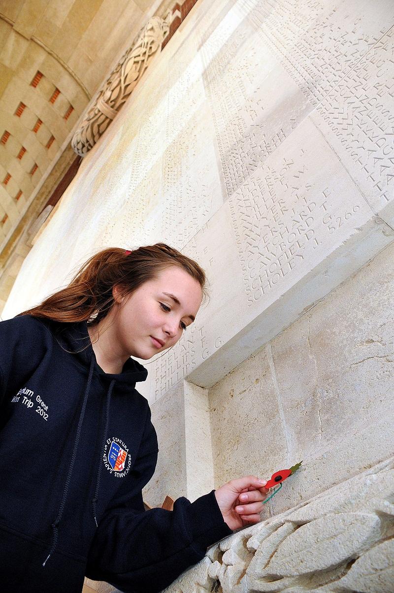 Olivia De-Juan places a poppy at the Thiepval Monument after finding the name of a  relative