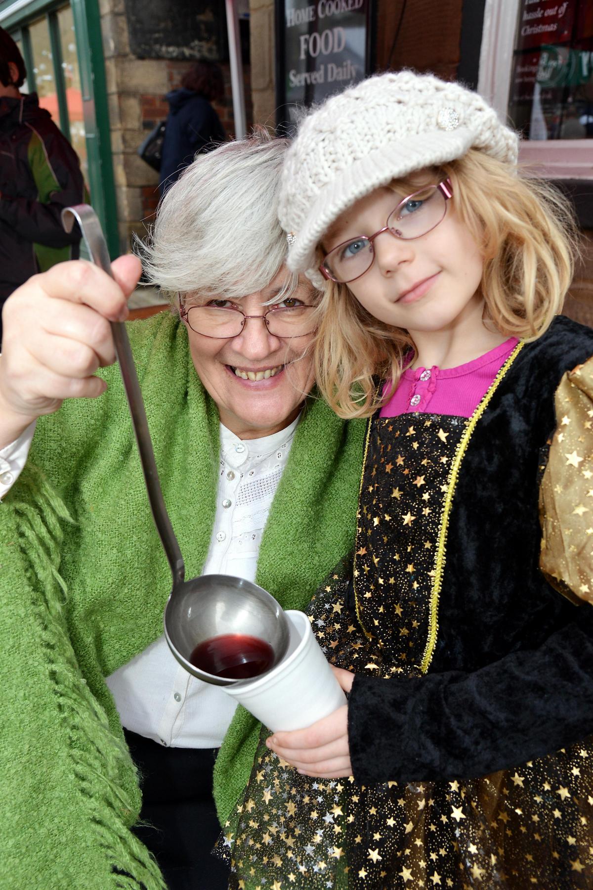 Maisey Green, seven, helps her grandmother Sandra Cooper with the mulled wine stall at Whitakers 