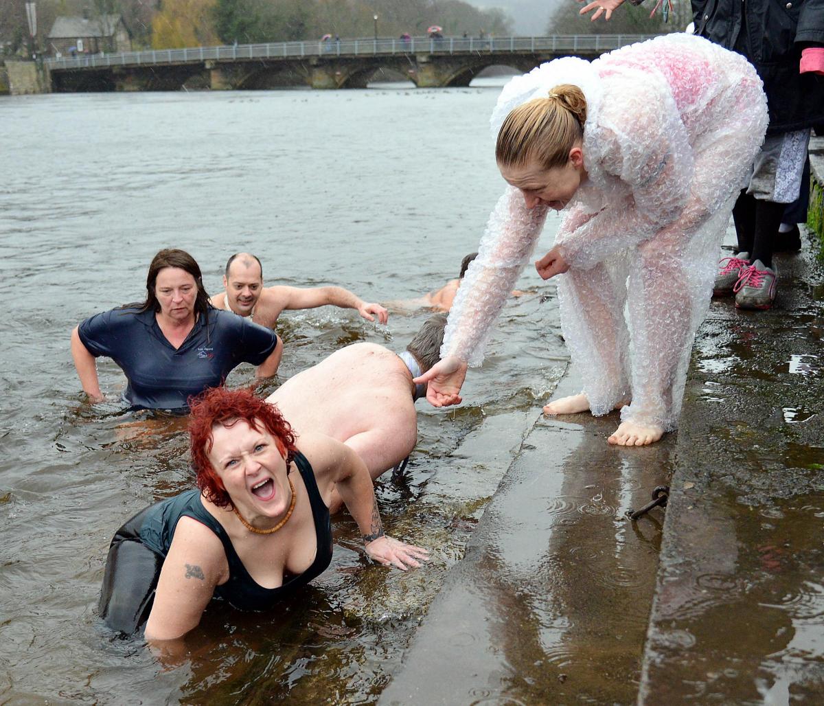 Swimmers at Otley being offered a hand out of the River Wharfe