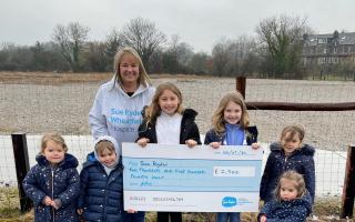 Sue Ryder fundraiser Lisa Grimes is receiving the cheque from (left to right) Lola, Myles, Annie, Myla, Aria and Ayda on behalf of the Houldsworth family