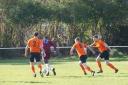 Otley Town (orange) chase down an East End Park (red) attacker on Saturday. Pic: Nicola Driffield