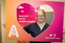 Nurse Andrea Ward, from the haematology and oncology day unit, with the hospital charity's logo