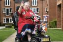 Judith has decorated her mobility scooter with Royal adornments including a corgi. Picture: Mike Simmonds