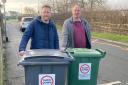 L-R: Cllrs Alderson and Wadsworth with two bins with the stickers warning against speeding