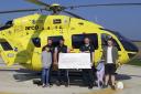 Ben Patel handing over his cheque to Yorkshire Air Ambulance