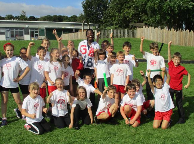Anyika Onuora with pupils at Burley and Woodhead Primary School during her visit