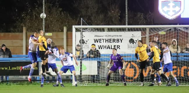 Guiseley (white) jump up for a header against Southport. Pic: Alex Daniel