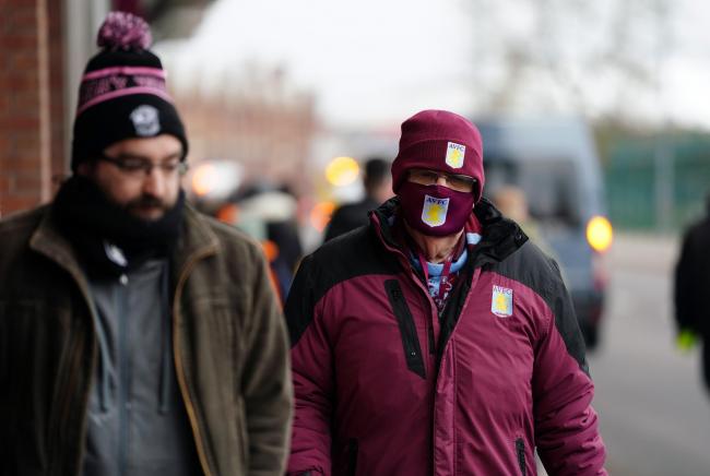 Fans walk away from the stadium following the news that Aston Villa's match against Burnley at Villa Park which has been postponed. Credit: PA