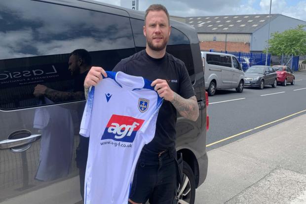 Spencer Harris (pictured) holding the new Guiseley home shirt