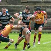 Ben Waddington (ball in hand) for Otley, wrestles away from a Sandal challenge. Pic: Chris Hyslop