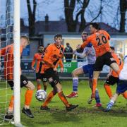 Andy Hollins (fourth left) watches his late winner into the net. Picture: Robert Leal.