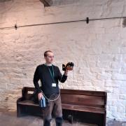 University of Bradford PhD student Joe Moore using a hand-held laser scanner to survey the interior of the Manor House. Photo: Alex Gibson