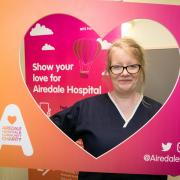 Nurse Andrea Ward, from the haematology and oncology day unit, with the hospital charity's logo