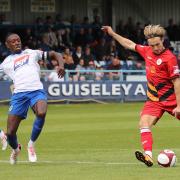 Guiseley (white) conceded a late leveller on Tuesday evening
