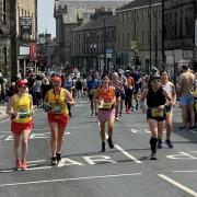 Runners in the 2024 Leeds Marathon heading through Otley