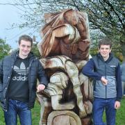 Olympic medallist triathletes Alistair (left) and Jonny Brownlee with a sculpture called Triathlon in their home village of Bramhope