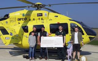 Ben Patel handing over his cheque to Yorkshire Air Ambulance