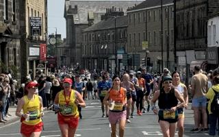 Runners in the 2024 Leeds Marathon heading through Otley